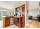 Built-in wet bar with wine cooler and glass shelving at 10518 Christopher Dr, Conifer, CO 80433