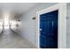 Indoor hallway with blue door and neutral walls at 5255 Memphis St # 917, Denver, CO 80239