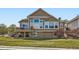 Expansive backyard showcasing a deck, large windows, and a lush lawn, perfect for outdoor enjoyment at 6642 S Routt St, Littleton, CO 80127