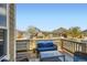 Relaxing balcony with outdoor seating, providing a view of the neighborhood and blue sky at 6642 S Routt St, Littleton, CO 80127