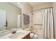 Accessible bathroom with safety bars, tile floors and a shower tub combination at 6642 S Routt St, Littleton, CO 80127