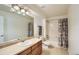 Bright bathroom featuring a well-lit mirror, updated vanity, and a shower-tub combination at 6642 S Routt St, Littleton, CO 80127