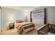 Cozy bedroom with neutral tones, a comfortable bed, and soft natural light through a window at 6642 S Routt St, Littleton, CO 80127
