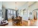 Formal dining room featuring wood floors, large windows, modern chandelier, and decorative trim at 6642 S Routt St, Littleton, CO 80127