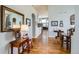 Open foyer with hardwood floors, decorative mirror, and furniture creates a welcoming entrance at 6642 S Routt St, Littleton, CO 80127