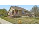 Charming home exterior with manicured landscaping, a welcoming front porch, and a well-kept lawn at 6642 S Routt St, Littleton, CO 80127