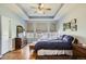 Generous primary bedroom with plenty of natural light, tray ceilings, and beautiful wood floors at 6642 S Routt St, Littleton, CO 80127