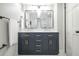 Bathroom featuring a double vanity with undermount sinks, brass fixtures, and a modern, minimalist design at 8511 Cherry Ln, Westminster, CO 80031