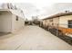 View of the long driveway leading to a black metal gate between two houses at 8511 Cherry Ln, Westminster, CO 80031
