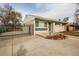Charming home featuring a black metal gate, tidy front yard, and neutral exterior paint at 8511 Cherry Ln, Westminster, CO 80031