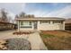 Charming single-story home featuring a well-maintained front yard, neutral paint, and inviting front door at 8511 Cherry Ln, Westminster, CO 80031