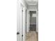 Hallway featuring wood flooring, multiple doors, and neutral paint at 8511 Cherry Ln, Westminster, CO 80031