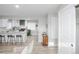 Open concept kitchen with a central island, barstool seating, and modern light fixtures at 8511 Cherry Ln, Westminster, CO 80031