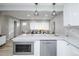 Open-concept kitchen and living area with stainless steel appliances and modern design at 8511 Cherry Ln, Westminster, CO 80031