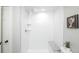 Modern shower with white subway tiles and a built-in granite-look bench seat and a rain-style showerhead at 8511 Cherry Ln, Westminster, CO 80031