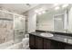 Well-lit bathroom with a shower, stylish tile, granite counters, and ample lighting at 3332 Valentia St, Denver, CO 80238