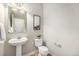 Charming powder room with pedestal sink, modern fixtures, and stylish decor at 3332 Valentia St, Denver, CO 80238