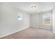 Bright bedroom features neutral carpet, baseboard, and two windows at 3332 Valentia St, Denver, CO 80238