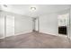 Neutral bedroom with carpet, baseboard, closet, and entry to ensuite bathroom at 3332 Valentia St, Denver, CO 80238