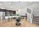 Open-concept dining area with hardwood floors, modern lighting, and seamless access to the kitchen at 3332 Valentia St, Denver, CO 80238
