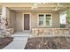 Welcoming front porch with stone accents, a cozy seating area, and the house number prominently displayed at 3332 Valentia St, Denver, CO 80238