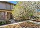 Charming two-story home featuring stone accents and blossoming trees in the front yard at 3332 Valentia St, Denver, CO 80238