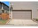 Attached one-car garage with concrete driveway and a satellite dish on the facade at 3332 Valentia St, Denver, CO 80238