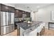 Stylish kitchen featuring stainless steel appliances, granite countertops, and a breakfast bar with seating at 3332 Valentia St, Denver, CO 80238