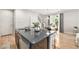 Sleek kitchen island with modern appliances, granite countertops, and views of the dining area at 3332 Valentia St, Denver, CO 80238