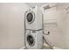 Convenient laundry room features a stacked washer and dryer with overhead storage at 3332 Valentia St, Denver, CO 80238