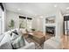 Inviting living room with a cozy fireplace, large windows, and comfortable seating arrangements at 3332 Valentia St, Denver, CO 80238