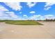 Expansive green park space featuring benches and paved walking paths under a sunny, blue sky at 3332 Valentia St, Denver, CO 80238