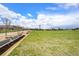 Lush green park offering inviting benches and paved walking paths under a blue sky with scattered clouds at 3332 Valentia St, Denver, CO 80238