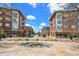 Lively town center with modern brick buildings, outdoor seating, and pedestrian-friendly walkways at 3332 Valentia St, Denver, CO 80238