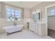 Bathroom featuring a clawfoot tub, vanity, and marble countertops at 41975 Muirfield Loop, Elizabeth, CO 80107