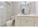 Bright bathroom featuring a glass shower, white vanity, and a stylish mirror at 41975 Muirfield Loop, Elizabeth, CO 80107