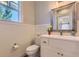 Stylish bathroom with beadboard paneling, unique faucet, and decorative mirror at 41975 Muirfield Loop, Elizabeth, CO 80107