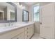 Bright bathroom featuring double vanity with white countertop, framed mirrors, and hexagon tile flooring at 41975 Muirfield Loop, Elizabeth, CO 80107