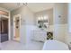 Bright bathroom featuring a glass shower, marble counters, white cabinets, and wainscotting at 41975 Muirfield Loop, Elizabeth, CO 80107