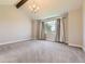 Bedroom with neutral carpet, vaulted ceilings with beam and decorative chandelier at 41975 Muirfield Loop, Elizabeth, CO 80107