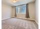 Basement bedroom with neutral walls, carpet, and egress window at 41975 Muirfield Loop, Elizabeth, CO 80107