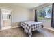 Bright bedroom with a large window offering scenic views of the surrounding greenery at 41975 Muirfield Loop, Elizabeth, CO 80107