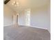 Carpeted bedroom with ensuite bathroom and closet featuring neutral walls and a chandelier at 41975 Muirfield Loop, Elizabeth, CO 80107