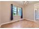 Bright bedroom featuring wood floors, ample natural light and stylish light fixture at 41975 Muirfield Loop, Elizabeth, CO 80107