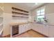 Well-appointed butler's pantry with wine fridge and custom shelving at 41975 Muirfield Loop, Elizabeth, CO 80107