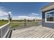 Relaxing deck featuring a white railing with hanging plants overlooking a lush yard at 41975 Muirfield Loop, Elizabeth, CO 80107