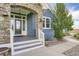 Home entryway features a stone archway, elegant lighting, and a welcoming front door at 41975 Muirfield Loop, Elizabeth, CO 80107