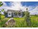 Beautiful blue home featuring a stone archway entrance, white trim, and a well-manicured lawn at 41975 Muirfield Loop, Elizabeth, CO 80107