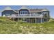 Exterior elevation showing the deck, yard, walkout basement, and wood shingle siding at 41975 Muirfield Loop, Elizabeth, CO 80107