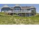 Back of a two-story home with a deck, stairs, and lovely blue siding at 41975 Muirfield Loop, Elizabeth, CO 80107